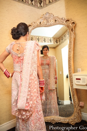 An Indian bride wears a baby pink lengha for her Indian wedding reception.