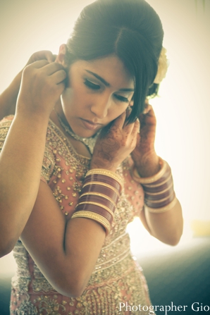 An Indian bride puts on an Indian bridal jewelry set for her reception.