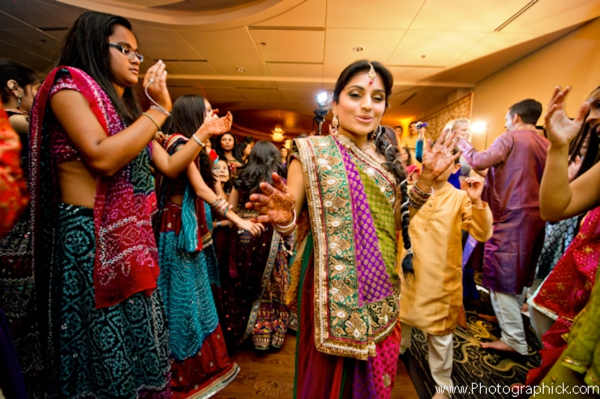 Indian bride dances at her traditional garba Indian wedding ceremony.