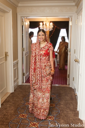 Indian bride wears a red wedding lengha.