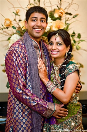 Portrait of Indian bride and groom at their Indian wedding garba party.