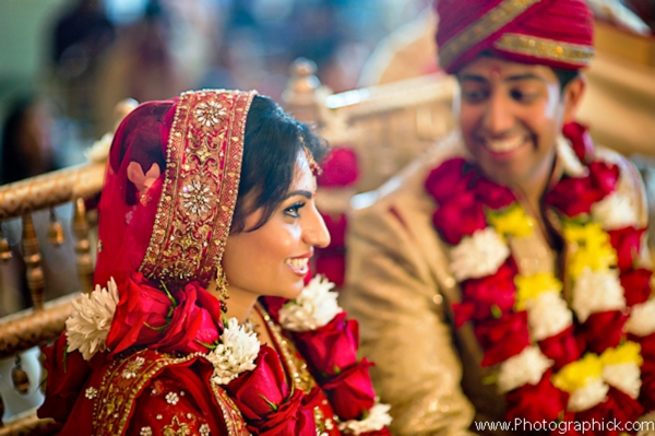 Indian bride wears traditional bridal lengha with matching jaimala.