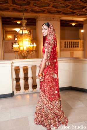 Indian bride wears classic red indian wedding lengha.