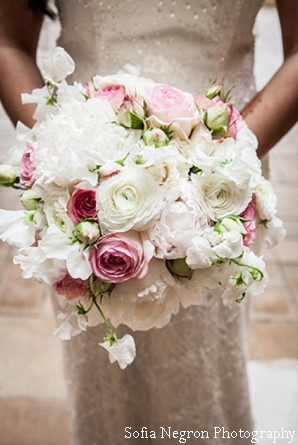 Indian bride with her pink and white flower bouquet