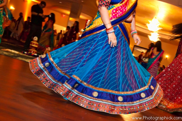 Indian bride twirls in a multicolored blue bridal sari.