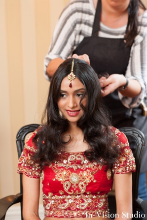 indian bride in red wedding lengha get indian bridal hair completed