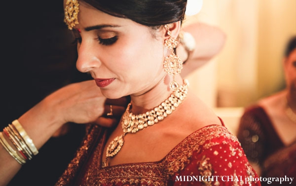 Indian bride puts on indian bridal jewelry set.