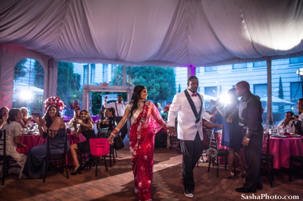 Indian bride and groom enter fusion indian wedding reception.