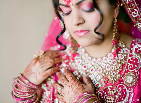 Indian bride in pink wedding lengha and bridal hair and makeup ideas