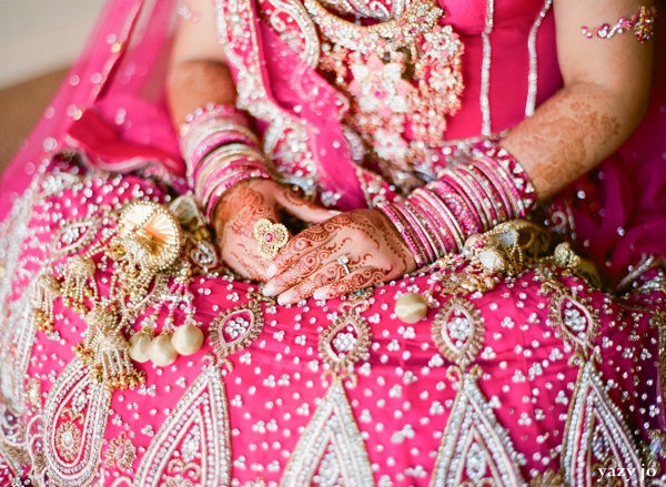 Indian wedding portrait of an indian bride in pink wedding lengha and bridal jewelry