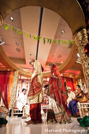 Indian bride and groom under mandap at indian wedding ceremony.