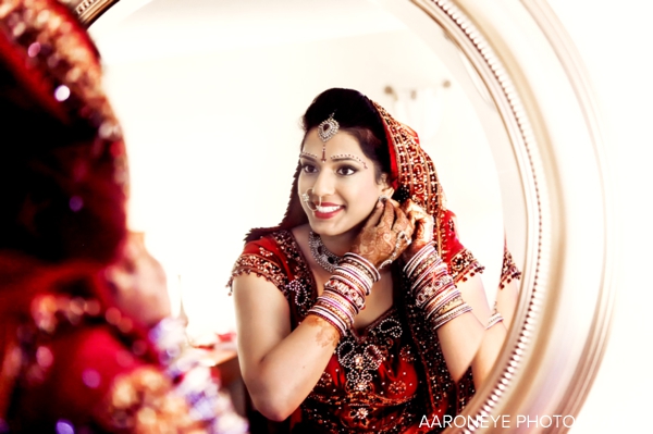 Indian bride in red wedding lengha with indian bridal jewelry