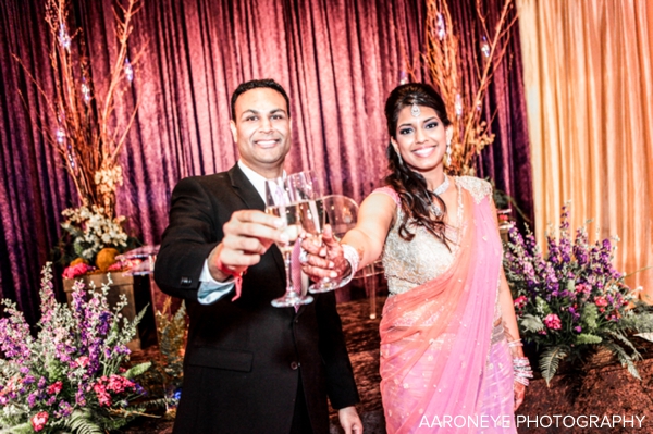 Indian bride in pink lengha at modern indian wedding reception
